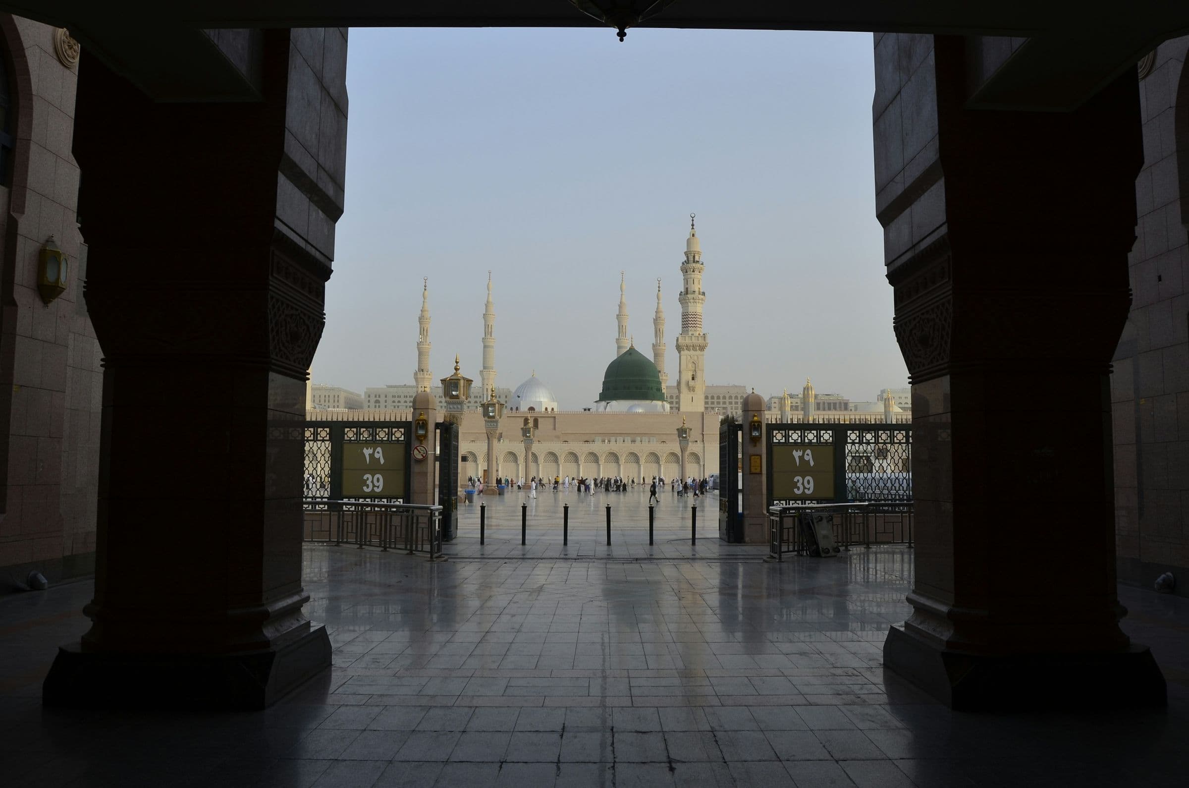 Prophet's Mosque and Green Dome framed through a dark arcade opening